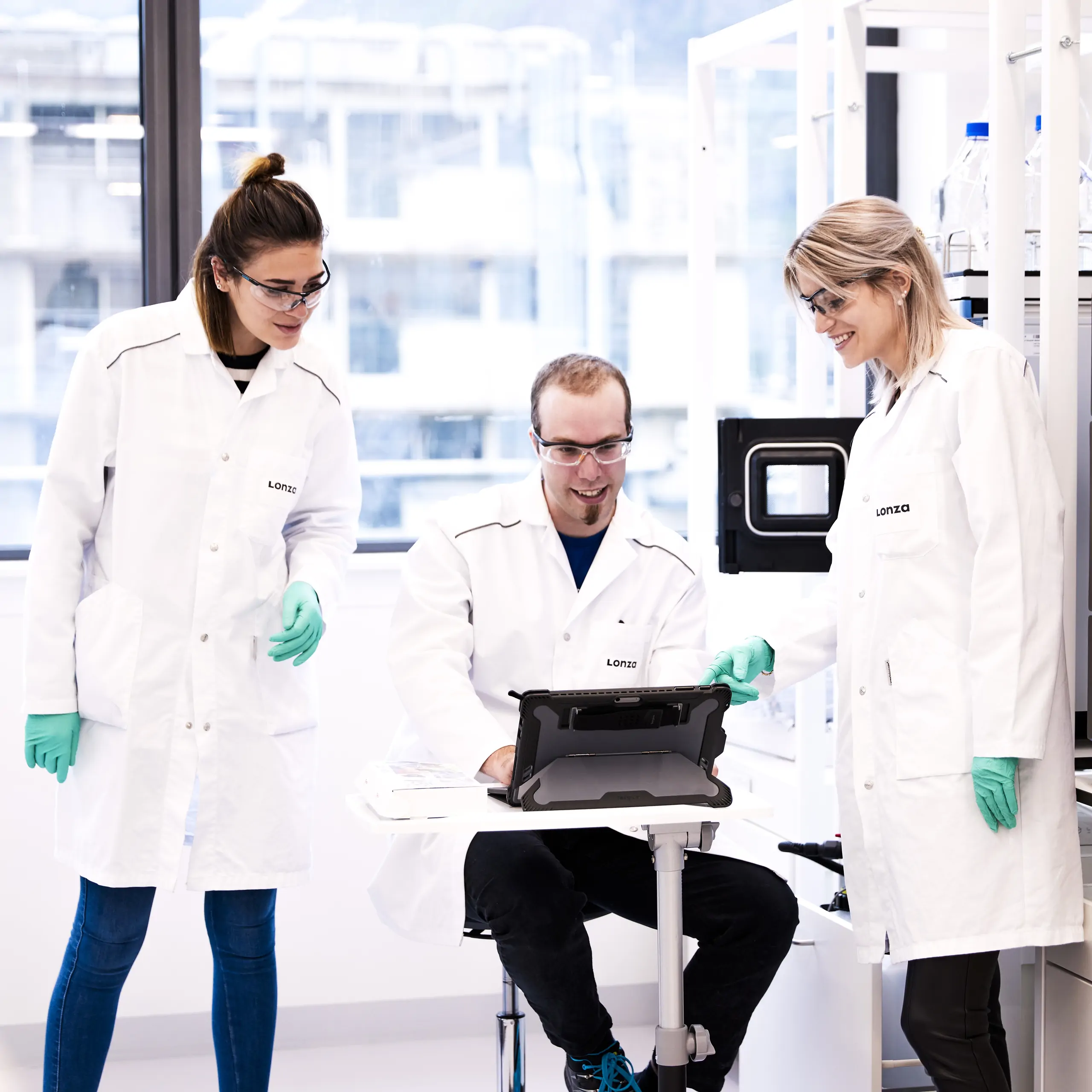 three techs working in lab
