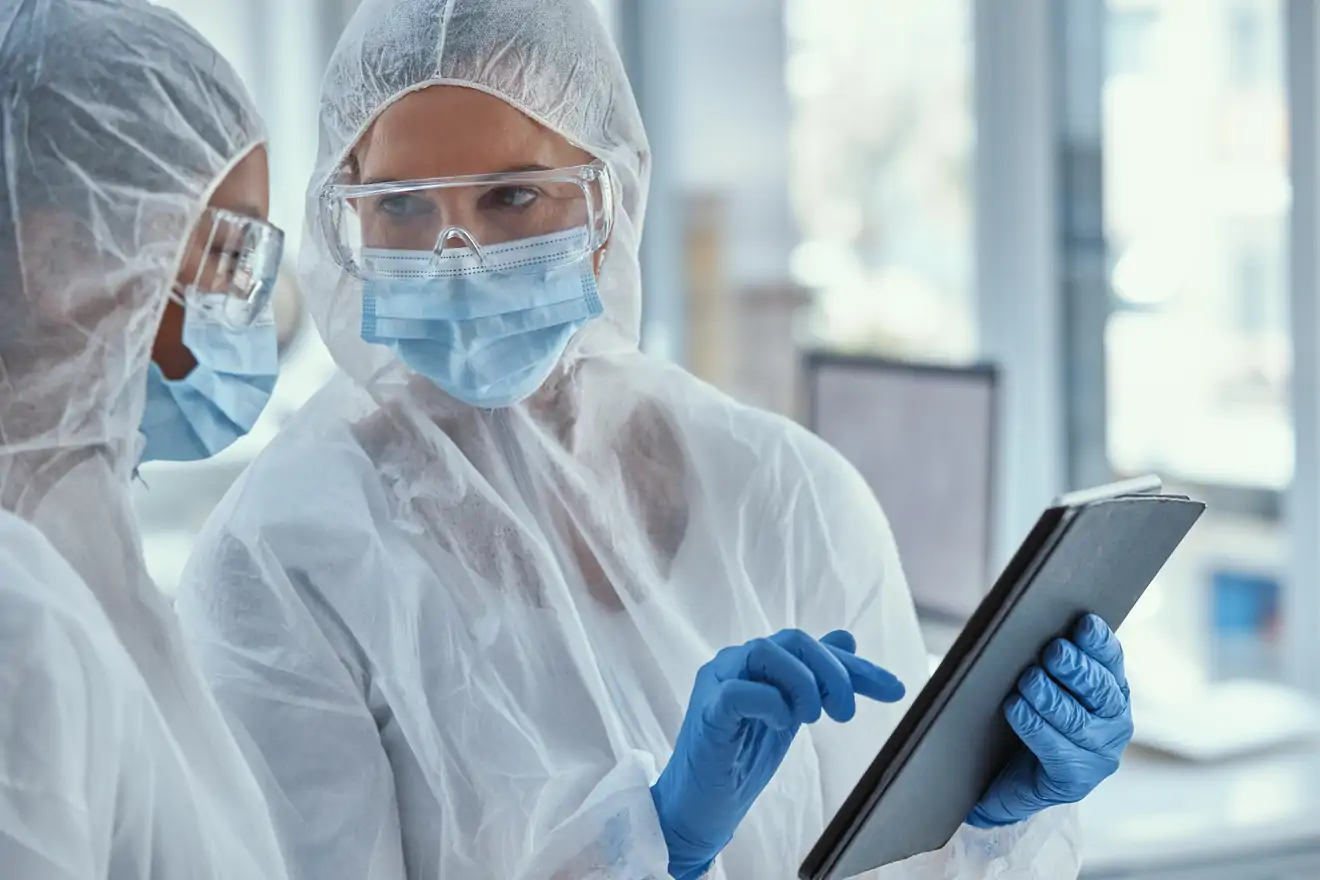 lab workers on tablet