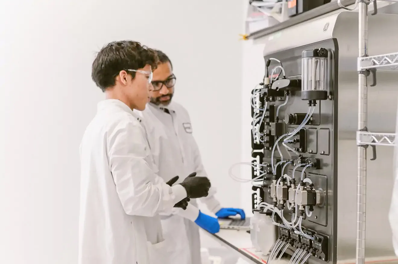 males working in lab on equipment